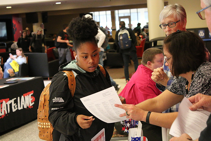 board of election staff helping student register to vote